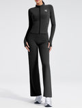 Black EVL fitted zip jacket with a high neckline and long sleeves.