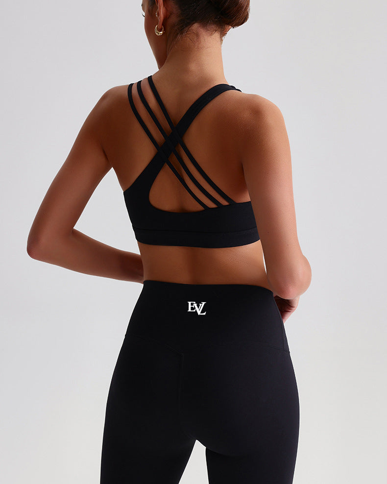 Black EVL sports bra featuring an asymmetric open-back strap design.