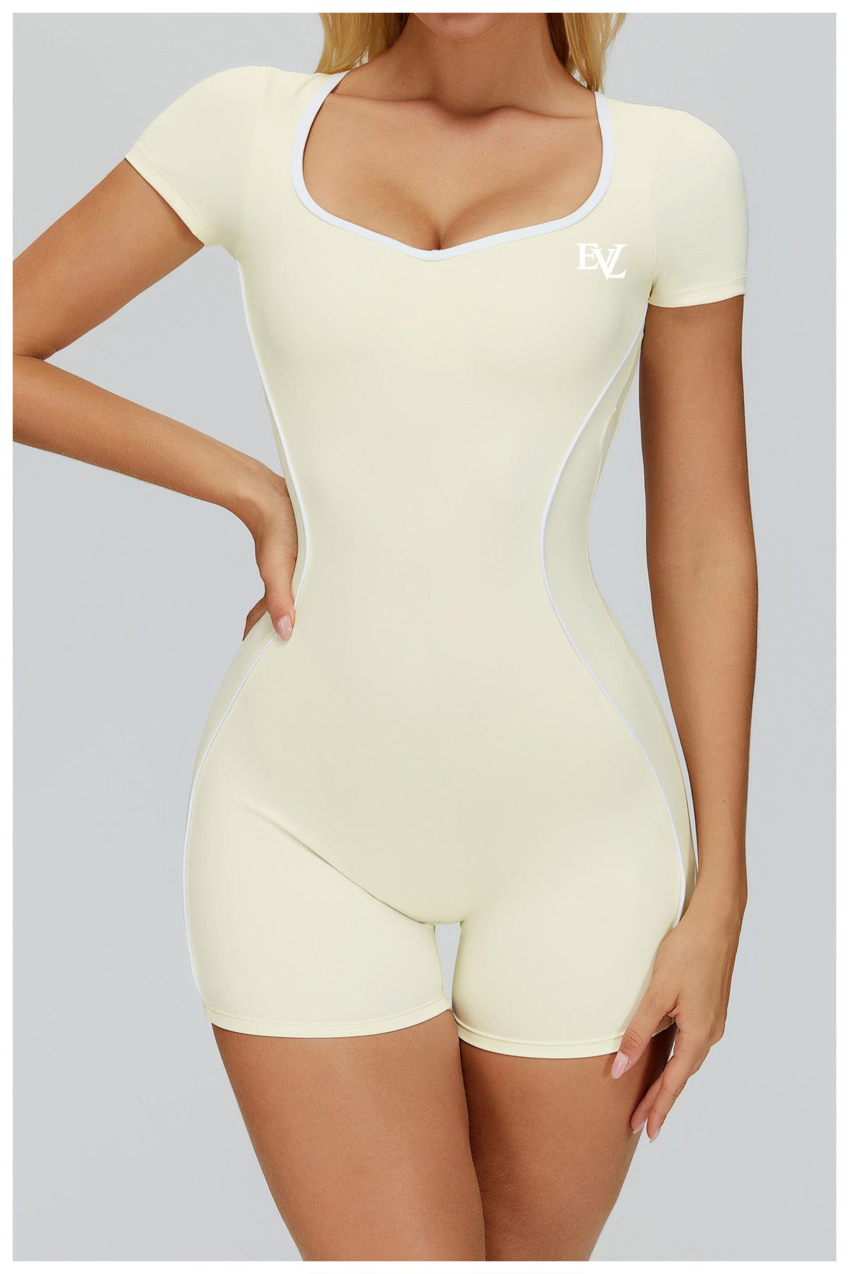 Cream EVL fitted short jumpsuit with a sweetheart neckline and short sleeves.