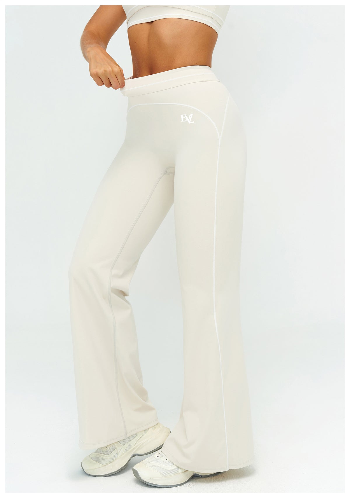 Cream EVL leggings with a distinctive flared-leg silhouette.
