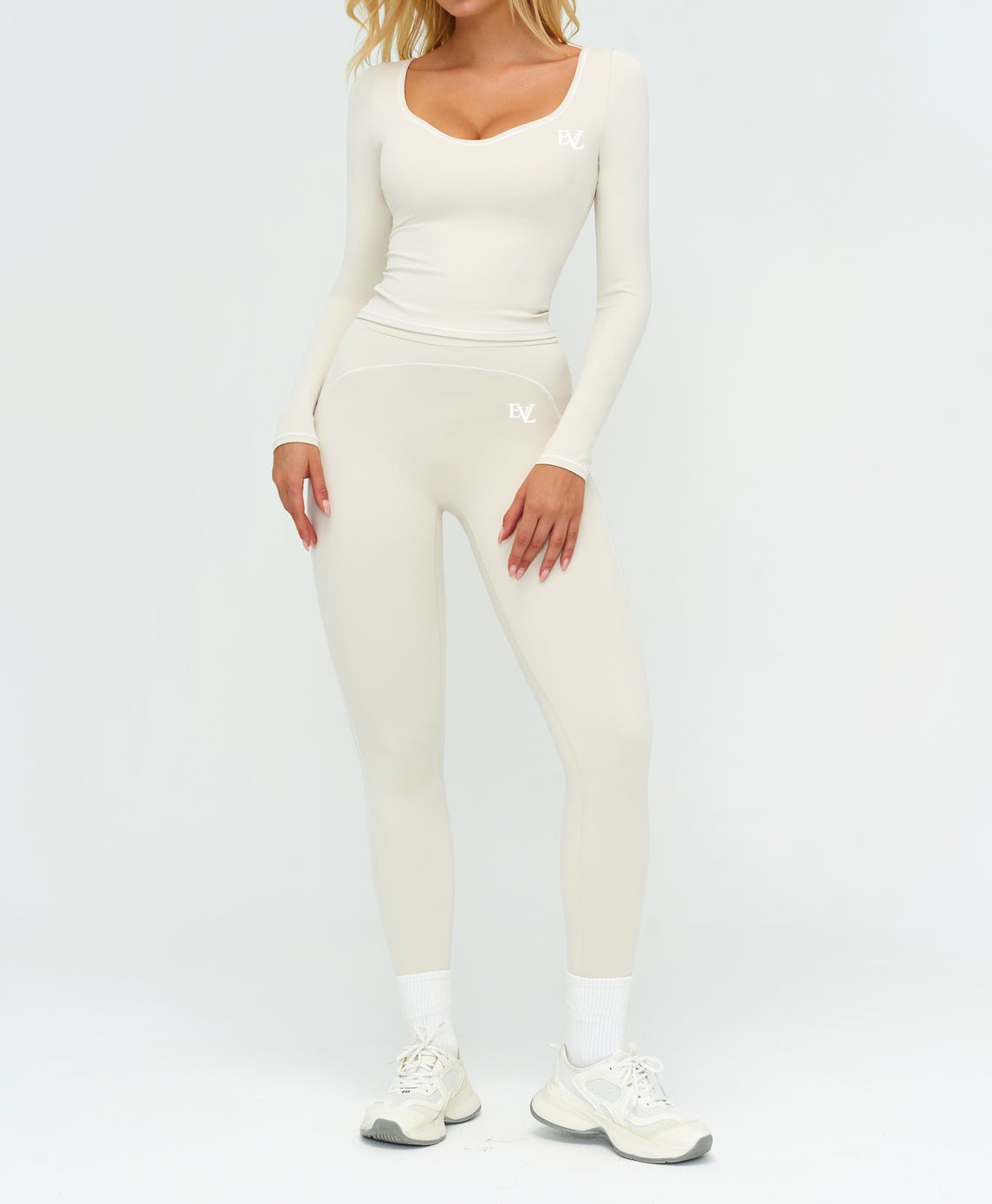 Cream EVL long-sleeve activewear top.