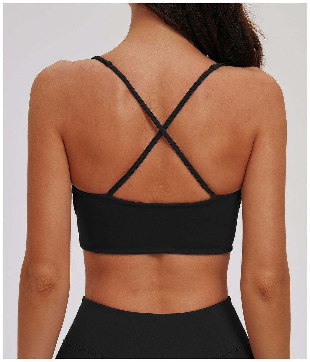 Black EVL cross-back sports bra with slim adjustable straps.