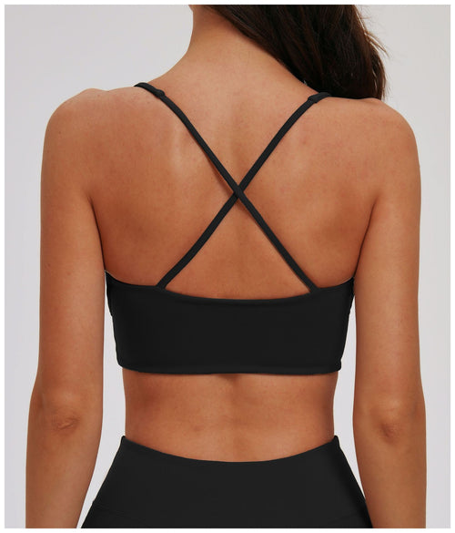 Black EVL cross-back sports bra with slim adjustable straps.