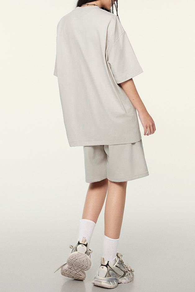 Additional view of the beige EVL T-shirt and shorts set.