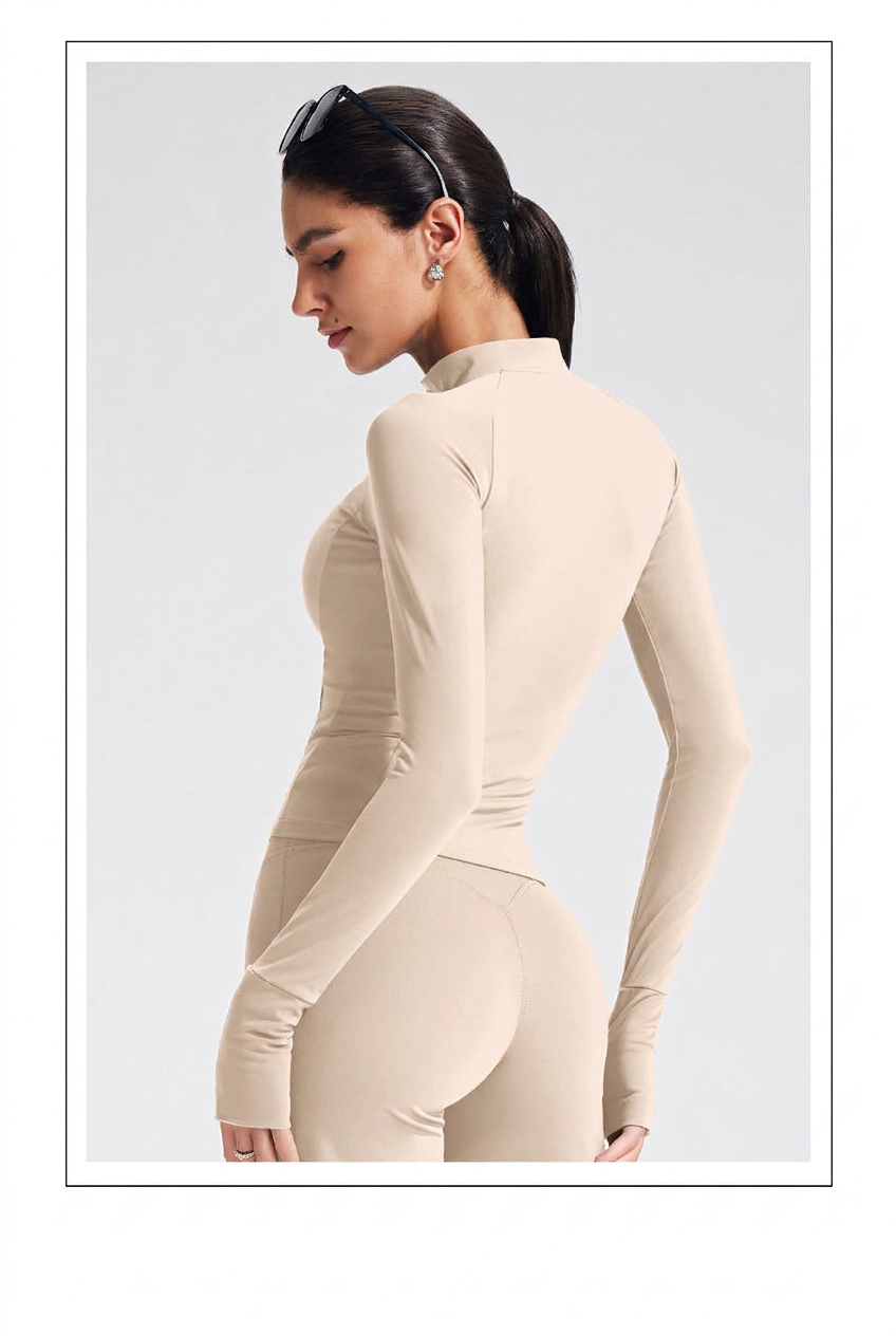 Additional view of the beige EVL zip jacket with long sleeves and fitted styling.