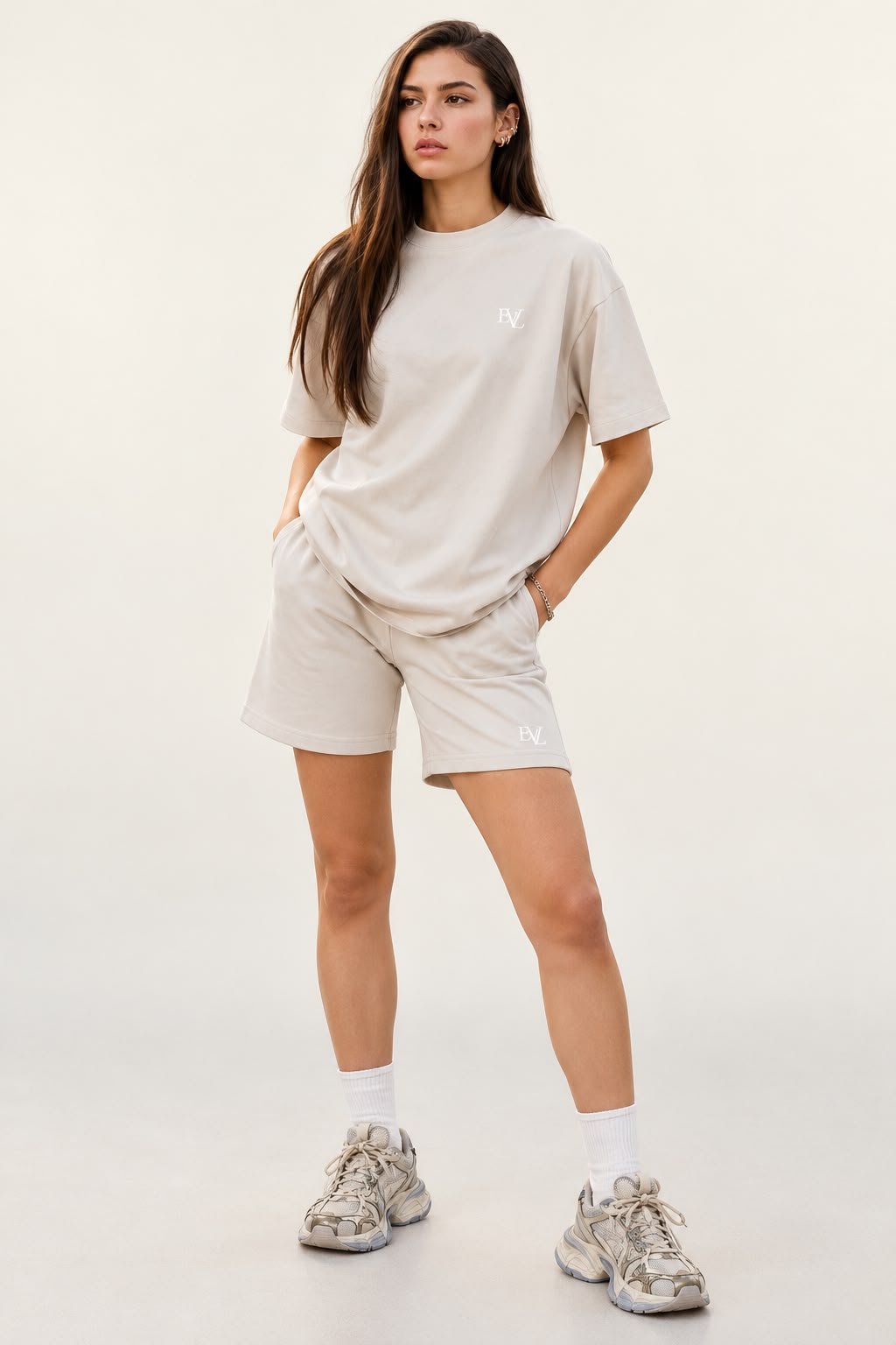 Model wearing the beige EVL unisex oversized T-shirt and matching shorts.